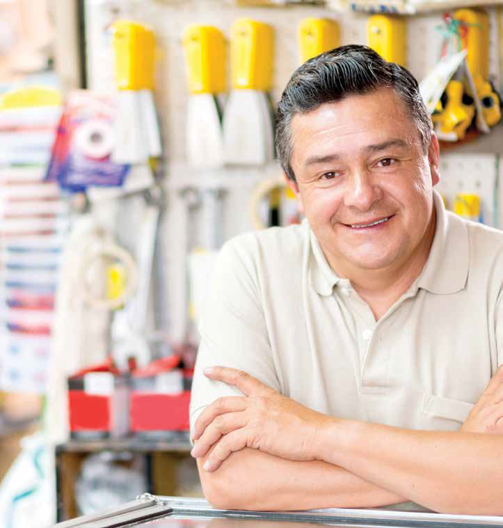 Friendly man working at a hardware store looking happy