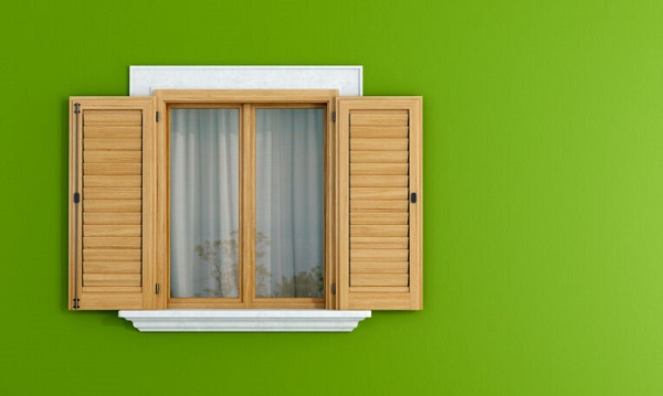 Wooden windows on green wall
