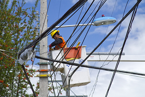 Osorno, Chile-November 6, 2011: An electrical power worker works in the connection of an power line in the city grid for the city of Osorno in the state of Los Lagos.