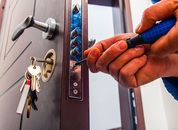 Handyman repairs the door lock
