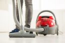 Woman,Vacuuming,The,House.,Close-up,With,Vacuum,Cleaner.