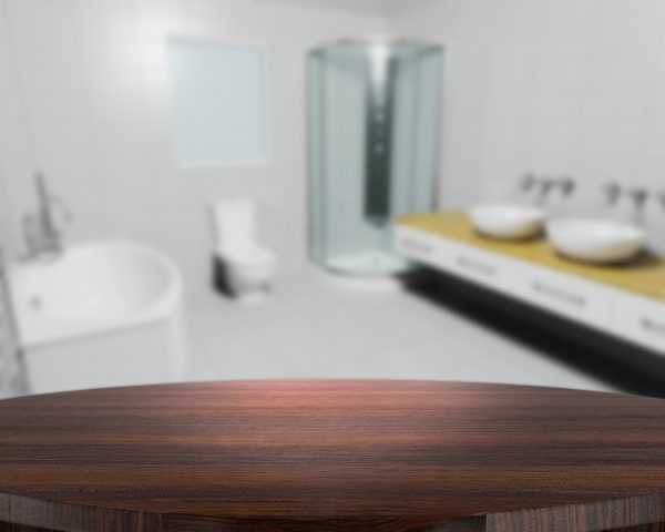 3D render of a wooden table with a defocussed contemporary bathroom in the background