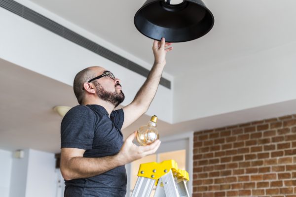 Man changing light bulb
