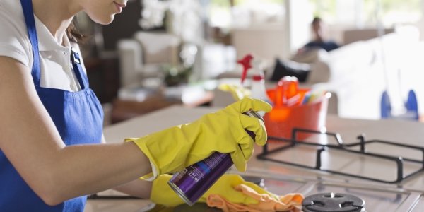 Maid cleaning stove top