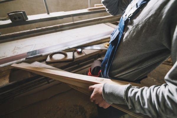 carpentry-concept-with-man-touching-wood